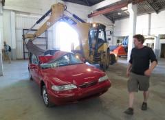 Fabricated meteorite, and crushed car. Fabrication and smoke, Cape Town